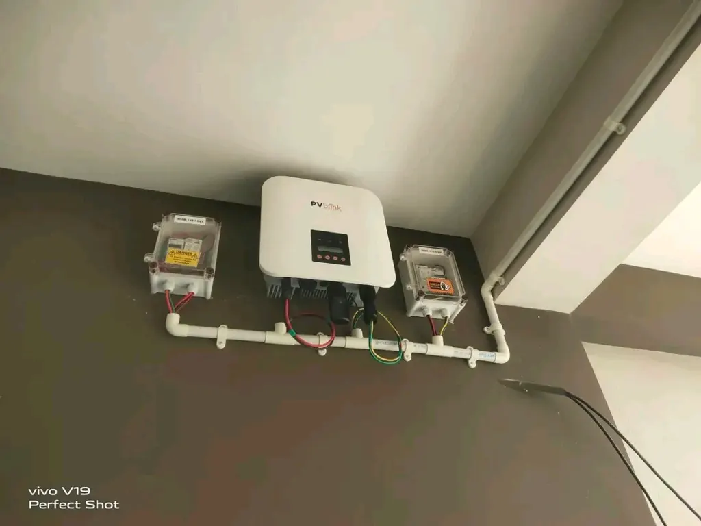 Solar inverter, DCDB and ACDB installation – SolarConnect India On-grid solar inverter with DCDB and ACDB boxes wall-mounted with neat PVC conduit wiring – SolarConnect India rooftop solar installation